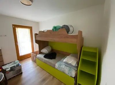 a bedroom with a bunk bed in a room at Appartamento Miramonti in Mas