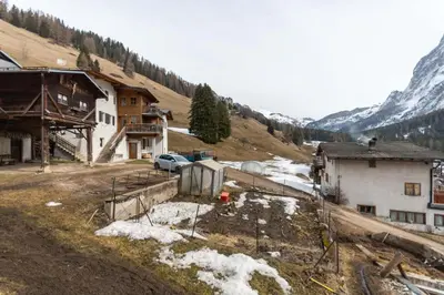 a group of buildings on a mountain with snow at Appartamento Iori in Canazei