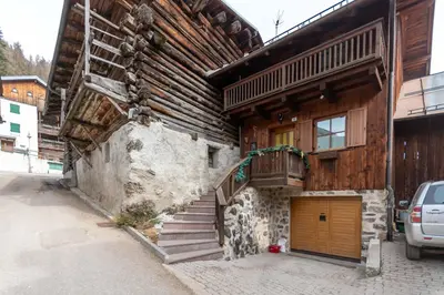a building with a staircase on the side of it at Appartamento Iori in Canazei
