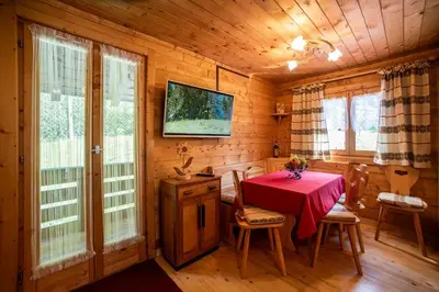 a dining room with a table in a log cabin at Fienile Rustico Alleghe Tabià in Alleghe