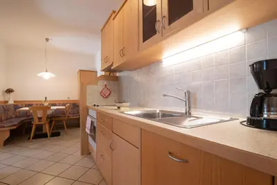 a kitchen with a sink and a counter top at Ferienwohnungen Fuchsleitenhof am See in Caldaro