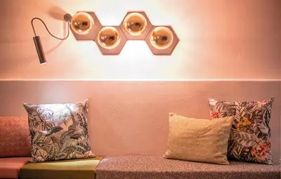 a room with a couch with a pair of glasses on the wall at Hotel Condor in San Vigilio Di Marebbe