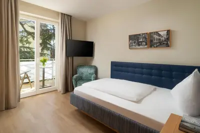 a hotel room with a bed and a window at Villa Bavaria in Merano