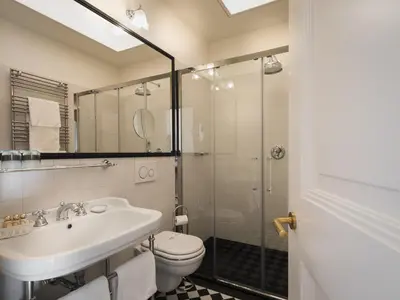 a bathroom with a toilet and a sink and a shower at Villa Bavaria in Merano