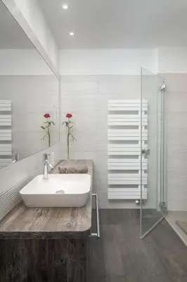 a bathroom with a sink and a glass shower at Villa Bavaria in Merano