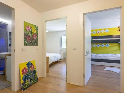 a room with a bedroom with a bed and a mirror at Apartment Enrosadira-13 by Interhome in Alba di Canazei