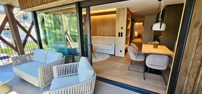 a room with chairs and a table and a living room at Mountain Residence CLARA in Riscone