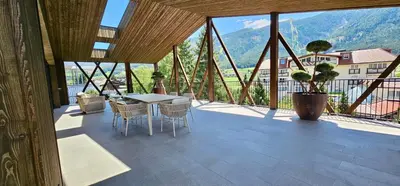 a large room with a table and chairs on a balcony at Mountain Residence CLARA in Riscone
