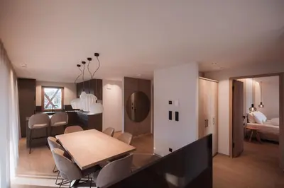 a dining room and living room with a table and chairs at Mountain Residence CLARA in Riscone