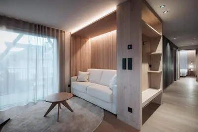 a living room with a white couch and a table at Mountain Residence CLARA in Riscone