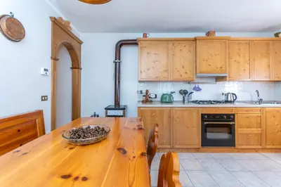 a kitchen with a wooden table with a bowl on it at Casa Caracoi in Rocca Pietore
