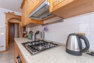 a kitchen with a stove top oven in a kitchen at Casa Caracoi in Rocca Pietore