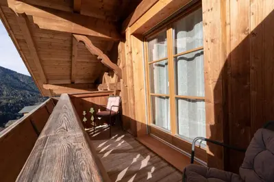 a balcony of a log cabin with a window at Winterlehof in Tires
