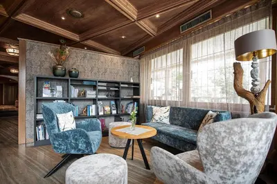 a living room with a couch and chairs and a table at Taubers Unterwirt Aktiv & Vitalhotel in Feldthurns