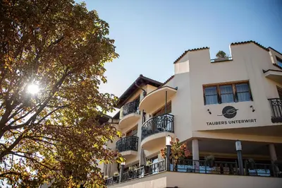 a building with a sign that reads turkey university at Taubers Unterwirt Aktiv & Vitalhotel in Feldthurns