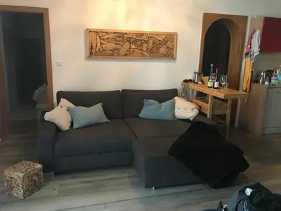 a living room with a couch and a table at Saringerhof in Rablà