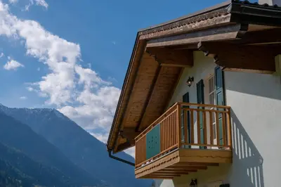 a balcony on the side of a building with mountains at La Casa Verde in Canale San Bovo