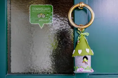 a door with a bird house keychain on it at La Casa Verde in Canale San Bovo