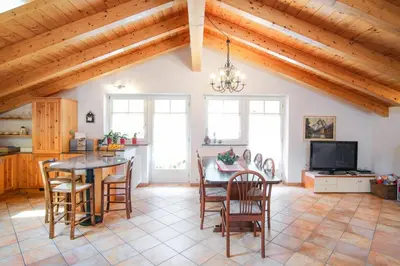 a kitchen and dining room with a table and chairs at La Casa Verde in Canale San Bovo