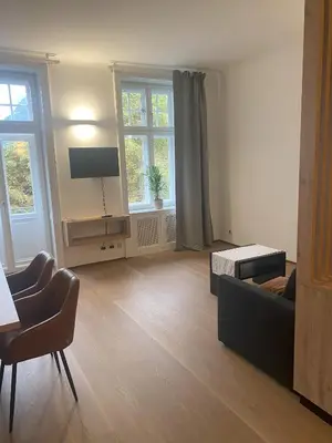 a living room with a couch and a tv at Appartament Tribulaun in Colle Isarco