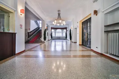 an empty hallway of a building with a chandelier at Appartament Tribulaun in Colle Isarco