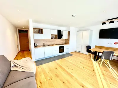 a living room with a couch and a table at Haus Gläserer apartments in Villandro