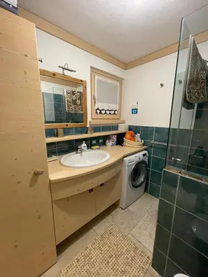 a bathroom with a sink and a washing machine at Love Mountain House in Campestrin