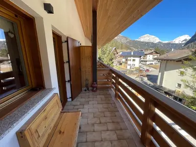 a balcony of a house with a view of the mountains at Love Mountain House in Campestrin