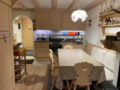 a kitchen with a table and chairs in it at Love Mountain House in Campestrin