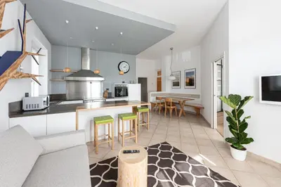 an open kitchen and living room with a table and chairs at La Finestra sul Peller, Coredo Ospitar in Coredo