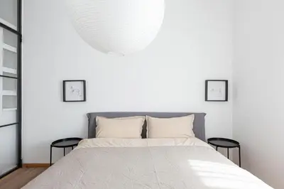 a bedroom with a large bed with two stools at La Finestra sul Peller, Coredo Ospitar in Coredo