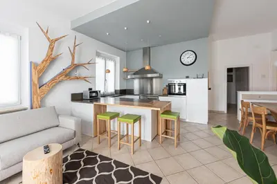 a kitchen and living room with a couch and a table at La Finestra sul Peller, Coredo Ospitar in Coredo