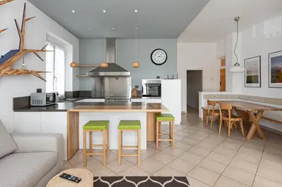 a kitchen and living room with a table and chairs at La Finestra sul Peller, Coredo Ospitar in Coredo