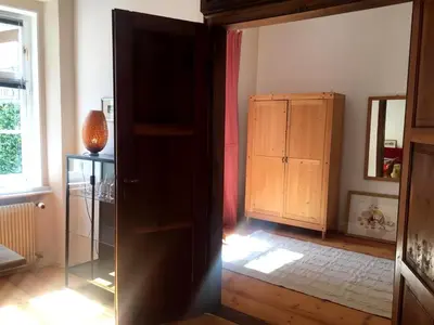 an open door to a room with a cabinet at Schöne Altstadtwohnung im Herzen der Stadt in Bolzano