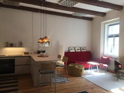 a kitchen with a table and chairs in a room at Schöne Altstadtwohnung im Herzen der Stadt in Bolzano