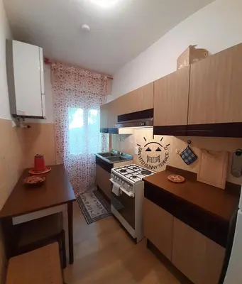 a small kitchen with a stove and a table at San Vito Sunny Terrace IT in San Vito di Cadore