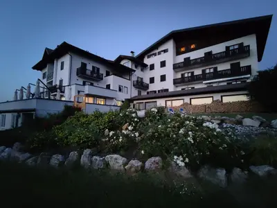 a large white building sitting on top of a hill at Enrosadira in Predaia