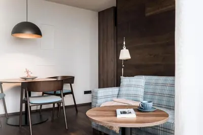 a room with a glass partition with a bed and a television at Bella Posta Hotel in Soprabolzano