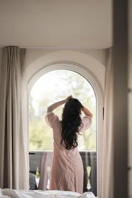 a hotel room with two beds and a window at Bella Posta Hotel in Soprabolzano
