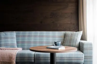 a bedroom with two beds and a side table at Bella Posta Hotel in Soprabolzano
