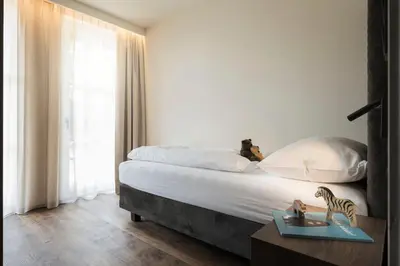 a living room with a table and a couch at Bella Posta Hotel in Soprabolzano