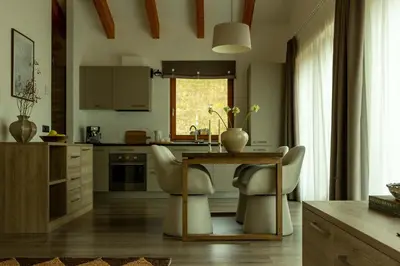 a kitchen with a table and two chairs and a table at Sass Pordoi Moena in Moena