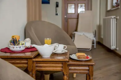 a table with a tray of breakfast food on it at Garnì Val de Grepa in Pozza di Fassa