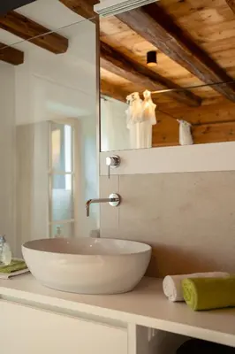 a bathroom with a white sink and a mirror at zuLAVOGL in Kastelruth