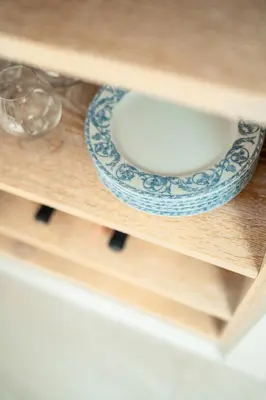 a plate on a shelf with a glass bowl at zuLAVOGL in Kastelruth