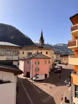 a view of a town with a church in the background at Simi Dolomiti in Predazzo