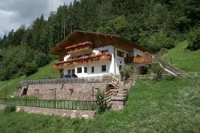 a house on the side of a hill at Agriturismo Kabishof in Funes