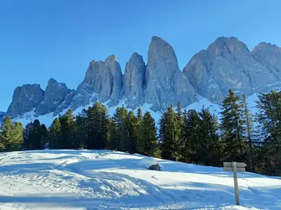 a golf course in the snow with mountains in the background at Agriturismo Kabishof in Funes