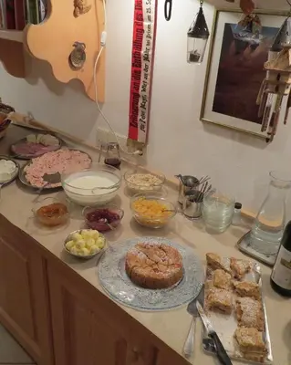 a counter with many different types of food on it at Agriturismo Kabishof in Funes