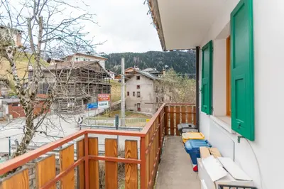 a living room with a door and a table at Casa Col di Frena in Falcade